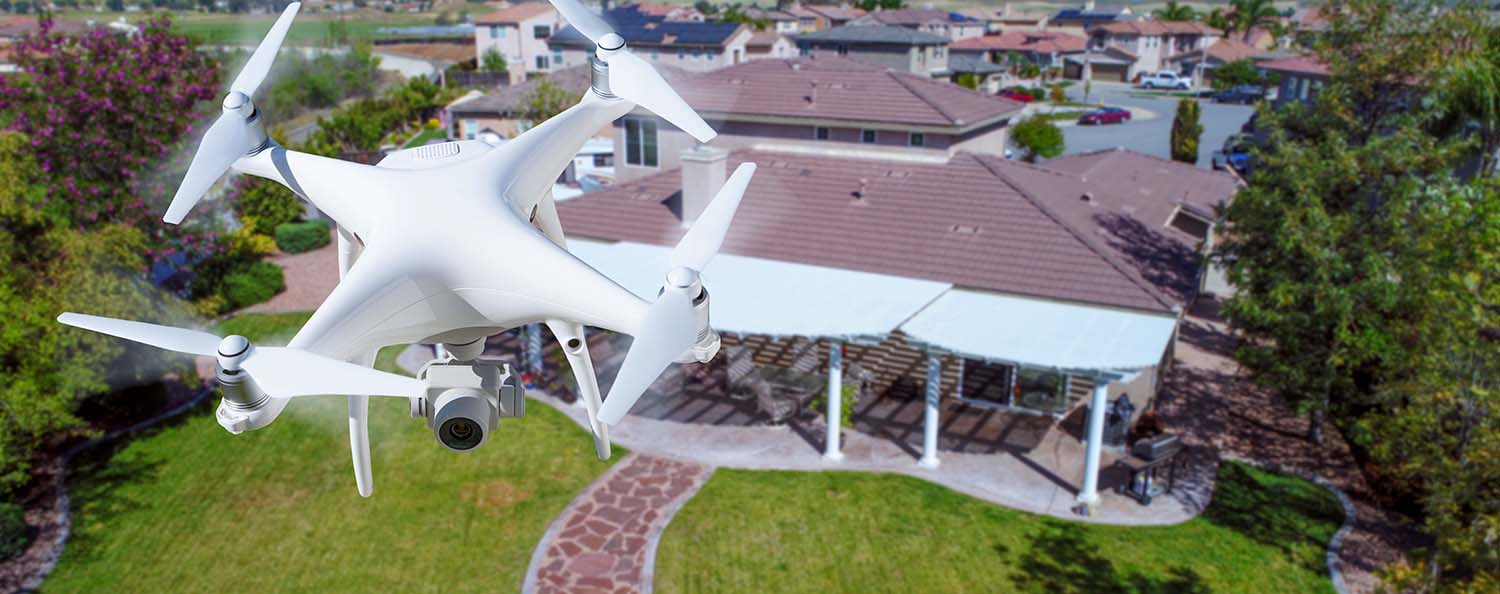 Aerial drone being flown by home inspector J. Corey Crawford over the roof a house